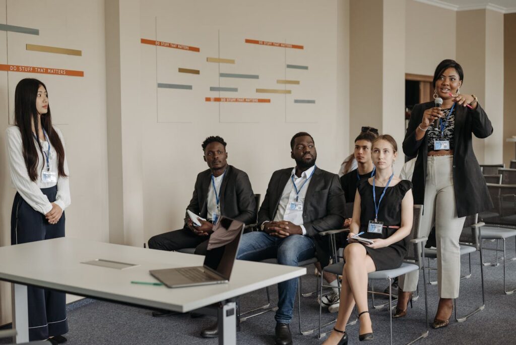 A diverse group of professionals attending a business seminar, actively participating and engaging in discussions.